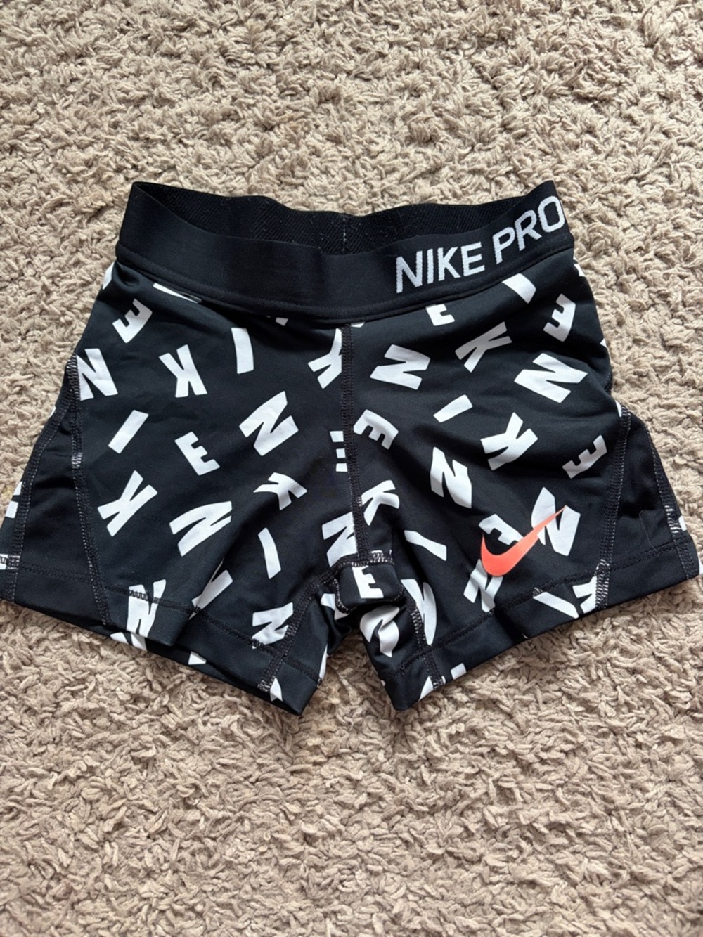Nike Black Compression Shorts with White Logo Print and Orange Swoosh